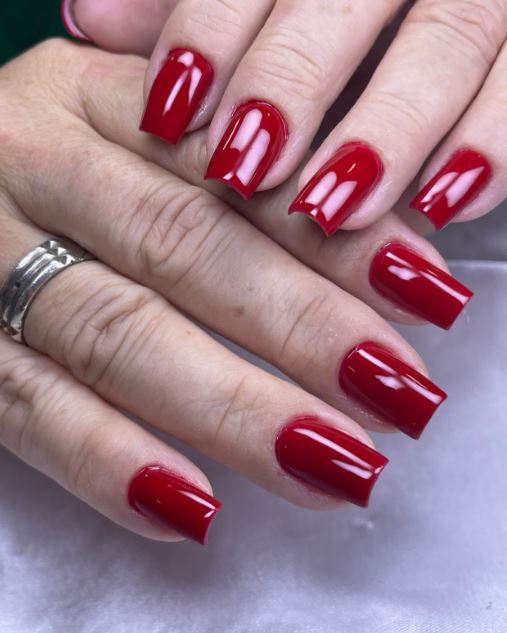 Unhas vermelhas com nail art delicada.