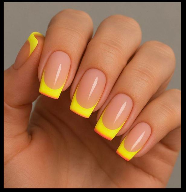 Unhas amarelas com efeito degradê moderno.