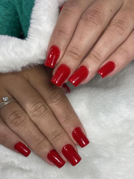 Unhas vermelhas com detalhes dourados.