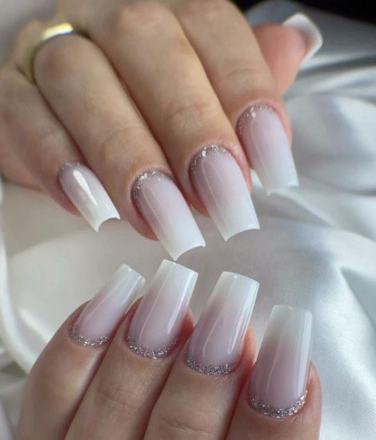Fotos de unhas brancas decoradas com glitter.